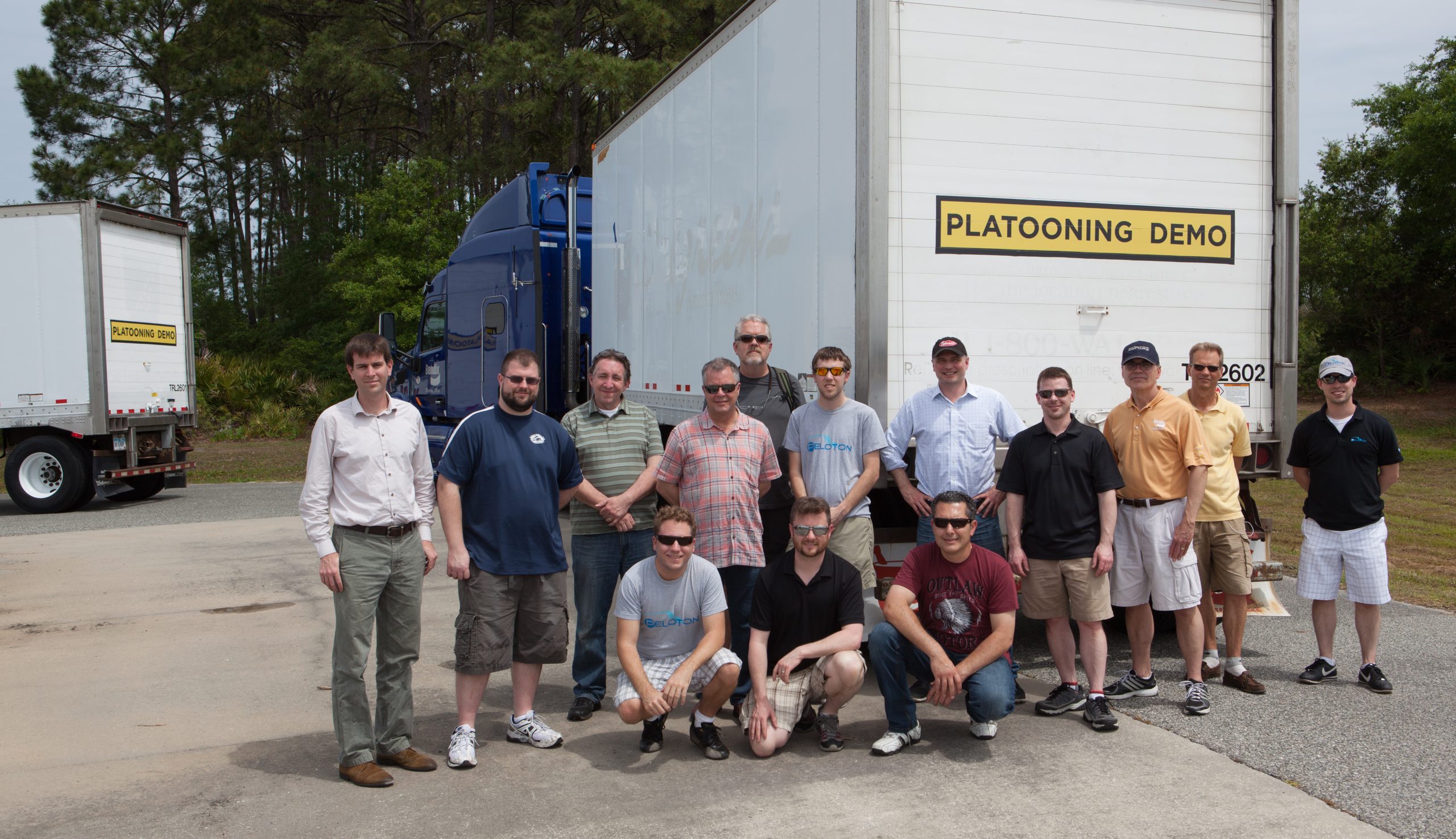Peloton crew pictured in front of a white trailer at the platooning demo