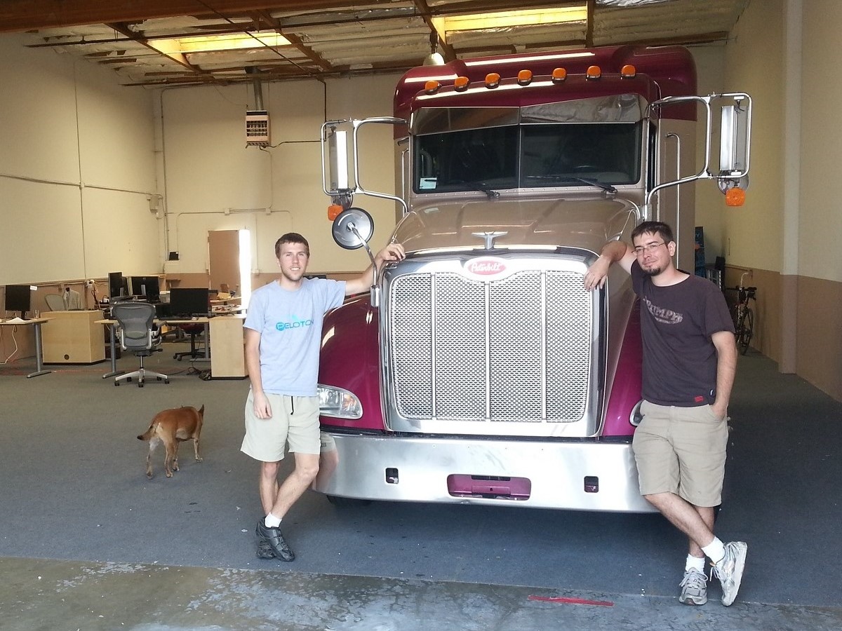 Alex (dog), Austin, and Joe standing beside a newly delivered truck